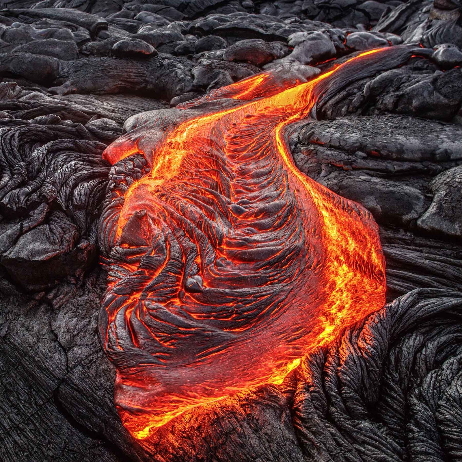 glowing red lava flow on black rock; https://cdn.shopify.com/videos/c/o/v/bf939861f1cd4cd8ba68eec80d57b280.mp4