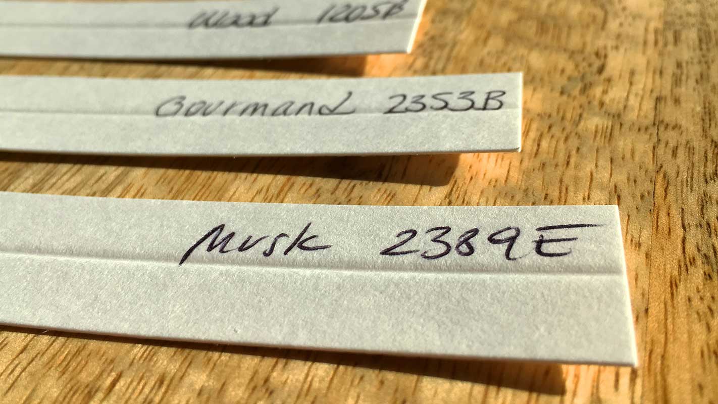 Stock Fragrance Resources - Fragrance Knowledge Center with Handwritten Notes on Wood Surface