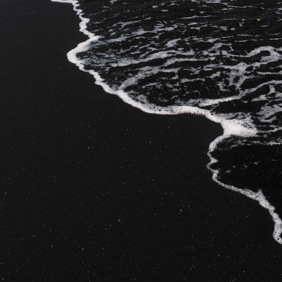 black volcanic sand beach with white sea foam; https://cdn.shopify.com/videos/c/o/v/e6917eb9e29e45f9ba5629fbfe25dd8d.mp4